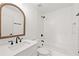 Bathroom with white hexagon tile, a white vanity, and wooden framed mirror at 1010 Edgewater Dr, Atlanta, GA 30328