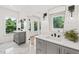 Double vanity bathroom with marble floors and gray cabinets at 1010 Edgewater Dr, Atlanta, GA 30328