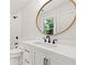 Modern bathroom with white vanity, frameless shower, and marble tile at 1010 Edgewater Dr, Atlanta, GA 30328