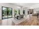 Bright dining room with deck access, open floor plan, and view of stone fireplace in living room at 1010 Edgewater Dr, Atlanta, GA 30328