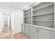 Bright hallway with built-in shelving and light gray cabinets at 1010 Edgewater Dr, Atlanta, GA 30328