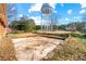 Large backyard with a patio and a water tower in the distance at 114 Woodhaven Dr, Stockbridge, GA 30281