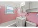 Retro bathroom with pink tile, white vanity, and shower/tub at 114 Woodhaven Dr, Stockbridge, GA 30281