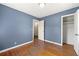 Simple bedroom with hardwood floors and blue walls at 114 Woodhaven Dr, Stockbridge, GA 30281