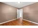 Simple bedroom featuring hardwood floors and neutral walls at 114 Woodhaven Dr, Stockbridge, GA 30281