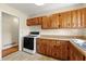 Classic kitchen with wood cabinets, gas range, and tile floor at 114 Woodhaven Dr, Stockbridge, GA 30281