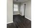 This bedroom features neutral paint, hardwood floors, and natural light from the window at 1971 Annette Ln, Austell, GA 30106