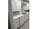 Clean kitchen with white cabinets and countertop, new dishwasher, and a modern sink at 1971 Annette Ln, Austell, GA 30106