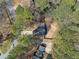 An aerial view of a home with a long driveway, set amidst mature trees and lush greenery at 3364 Sheree Trl, Stone Mountain, GA 30087