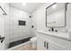 Bathroom with double vanity, black framed mirror, and a spacious tiled walk-in shower with a black showerhead at 3364 Sheree Trl, Stone Mountain, GA 30087