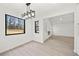 Well-lit dining room featuring recessed lights, a modern light fixture, and an entrance to the living room at 3364 Sheree Trl, Stone Mountain, GA 30087