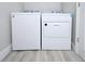 White washer and dryer set in a small laundry room at 284 Juliet Sw Ln, Marietta, GA 30008