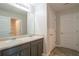 Double vanity bathroom with gray cabinets and neutral flooring at 3732 Stonebranch Ln, Loganville, GA 30052