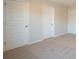 Well-lit bedroom with neutral carpeting and three closets at 3732 Stonebranch Ln, Loganville, GA 30052