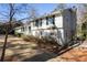 Charming two-story home featuring mature landscaping, a brick foundation, and classic black shutters at 4266 Valley Trail Se Dr, Atlanta, GA 30339