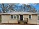 Beige brick ranch house with a wooden deck and black front door at 568 Mcwilliams Se Rd, Atlanta, GA 30315