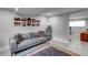 Finished basement room with gray sofa, rug, and framed pictures at 1974 Ellwyn Dr, Brookhaven, GA 30341