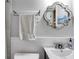 Small bathroom with white vanity, decorative mirror, and glass shelf at 1974 Ellwyn Dr, Brookhaven, GA 30341