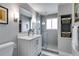 Clean bathroom with white vanity, glass shower, and gray tile at 1974 Ellwyn Dr, Brookhaven, GA 30341