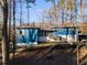 Ranch style home with blue siding, nestled in wooded setting at 1974 Ellwyn Dr, Brookhaven, GA 30341