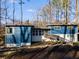 Mid-century modern home featuring a blue exterior and a spacious deck at 1974 Ellwyn Dr, Brookhaven, GA 30341