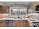 Updated kitchen featuring wood cabinets, quartz countertops, and a farmhouse sink at 1974 Ellwyn Dr, Brookhaven, GA 30341