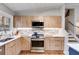 Modern kitchen with stainless steel appliances and wood cabinets at 1974 Ellwyn Dr, Brookhaven, GA 30341