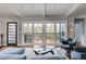 Bright living room featuring hardwood floors, large windows, and a modern aesthetic at 1974 Ellwyn Dr, Brookhaven, GA 30341