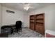 Basement office with wood bookshelves and neutral decor at 2013 Parador Bnd, Mcdonough, GA 30253