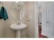 Small half bathroom with pedestal sink and oval mirror at 2013 Parador Bnd, Mcdonough, GA 30253