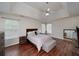 Main bedroom with tray ceiling, wood floors, and en-suite bathroom at 2013 Parador Bnd, Mcdonough, GA 30253