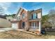 Two-story house with a brick facade, two-car garage, and a porch at 2013 Parador Bnd, Mcdonough, GA 30253