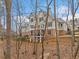 Spacious backyard of a house with a brick foundation, lush landscaping, and wooded views at 2109 Rocky Falls Nw Ct, Kennesaw, GA 30152