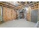 Unfinished basement featuring insulation, a utility area, and a door for storage or future expansion at 2109 Rocky Falls Nw Ct, Kennesaw, GA 30152