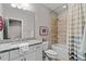 Bathroom featuring granite countertop, modern fixtures, and a tiled shower at 2109 Rocky Falls Nw Ct, Kennesaw, GA 30152