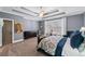 Well-lit bedroom boasts a tray ceiling, neutral colors, and a comfortable sitting area at 2109 Rocky Falls Nw Ct, Kennesaw, GA 30152