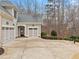 Home exterior featuring an attached garage, basketball hoop, and well-maintained landscaping at 2109 Rocky Falls Nw Ct, Kennesaw, GA 30152