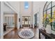 Grand foyer with soaring ceilings, hardwood floors, stylish rug, and a view to the front door at 2109 Rocky Falls Nw Ct, Kennesaw, GA 30152