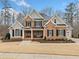 Charming two-story brick home with a manicured lawn, dark shutters, and an inviting entrance at 2109 Rocky Falls Nw Ct, Kennesaw, GA 30152