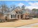 Inviting two-story brick home, complemented by dark shutters, lush greenery and a well-manicured lawn at 2109 Rocky Falls Nw Ct, Kennesaw, GA 30152