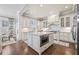 Bright kitchen features white cabinets, stainless steel appliances, and a center island with a built-in microwave at 2109 Rocky Falls Nw Ct, Kennesaw, GA 30152