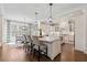 Gourmet kitchen with island seating and a dining nook illuminated by natural light at 2109 Rocky Falls Nw Ct, Kennesaw, GA 30152