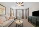 Living room featuring neutral colors, carpet, and a ceiling fan at 2109 Rocky Falls Nw Ct, Kennesaw, GA 30152