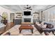 Spacious living room with coffered ceilings, a fireplace, and built-in shelving for stylish storage and display at 2109 Rocky Falls Nw Ct, Kennesaw, GA 30152