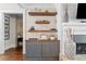 Living area featuring a built-in cabinet, floating shelves, and a white fireplace at 2109 Rocky Falls Nw Ct, Kennesaw, GA 30152