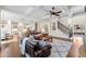 Open-concept living room with a coffered ceiling, staircase, and seamless access to the modern kitchen at 2109 Rocky Falls Nw Ct, Kennesaw, GA 30152