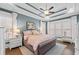 Tranquil main bedroom featuring a tray ceiling, plantation shutters, and elegant decor at 2109 Rocky Falls Nw Ct, Kennesaw, GA 30152