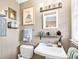 Clean bathroom with white vanity, toilet, and a decorative framed print at 3414 Alcan Way, Tucker, GA 30084