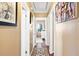 Long hallway with neutral walls, hardwood floors, and framed artwork at 3414 Alcan Way, Tucker, GA 30084