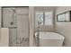 Spa-like bathroom with soaking tub and walk-in shower at 409 E Point Dr, Canton, GA 30115